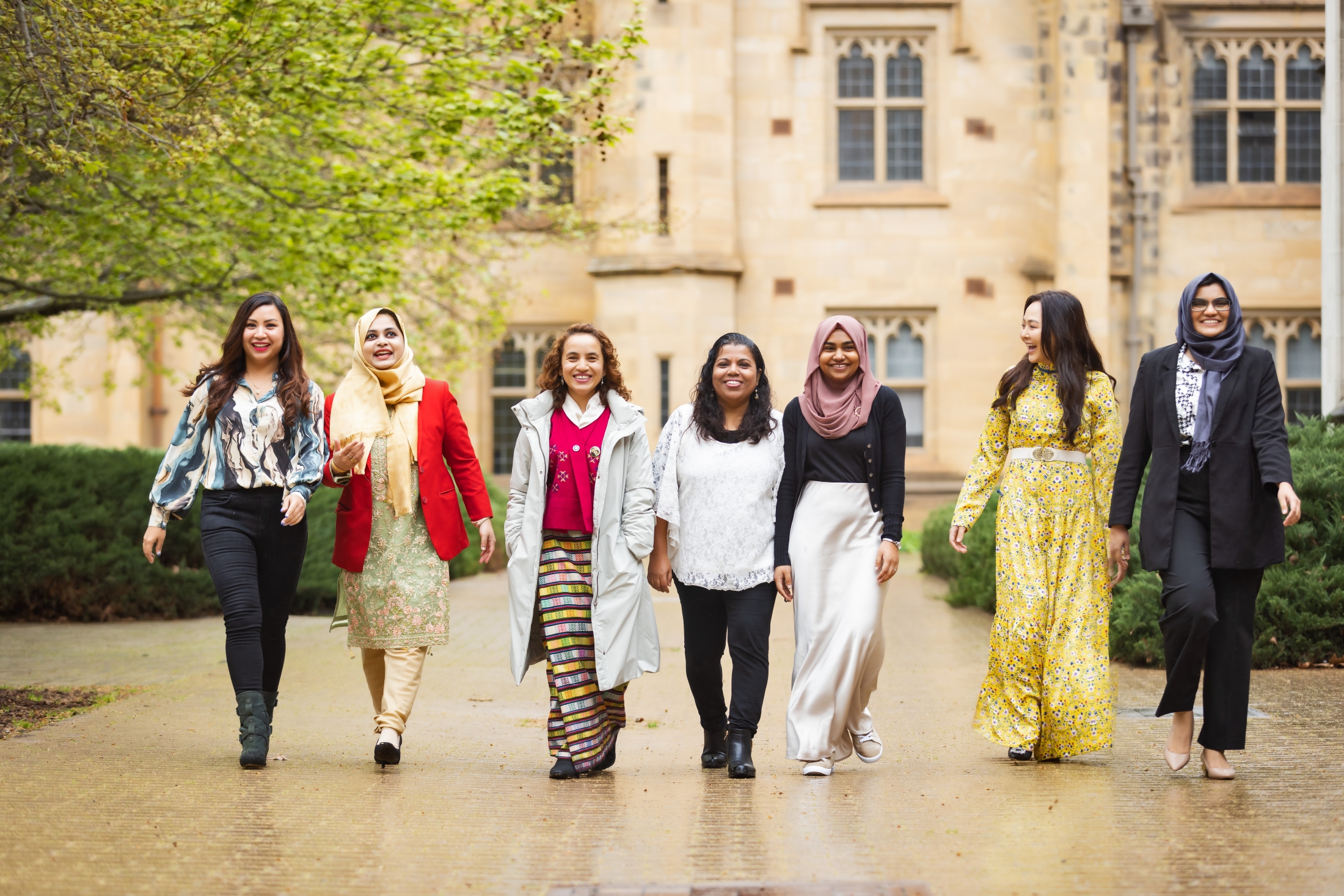 Aminath and other Australia Awards scholars from South Asia and Mongolia walking in a line on the grounds of the University of Melbourne