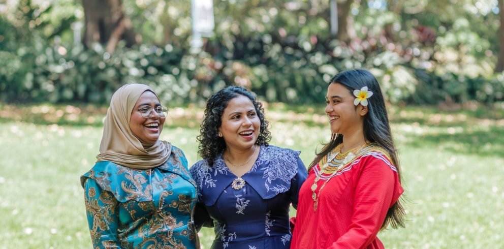 Three Maldivian women talk together outdoors
